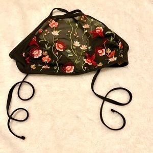 A bikini top with black and roses on it